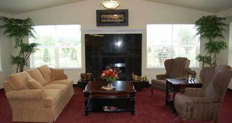 A cozy living room with sofas, a coffee table, and a fireplace.