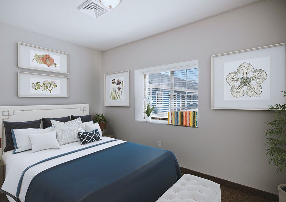 A modern bedroom with stylish artwork, natural light, and cozy decor.