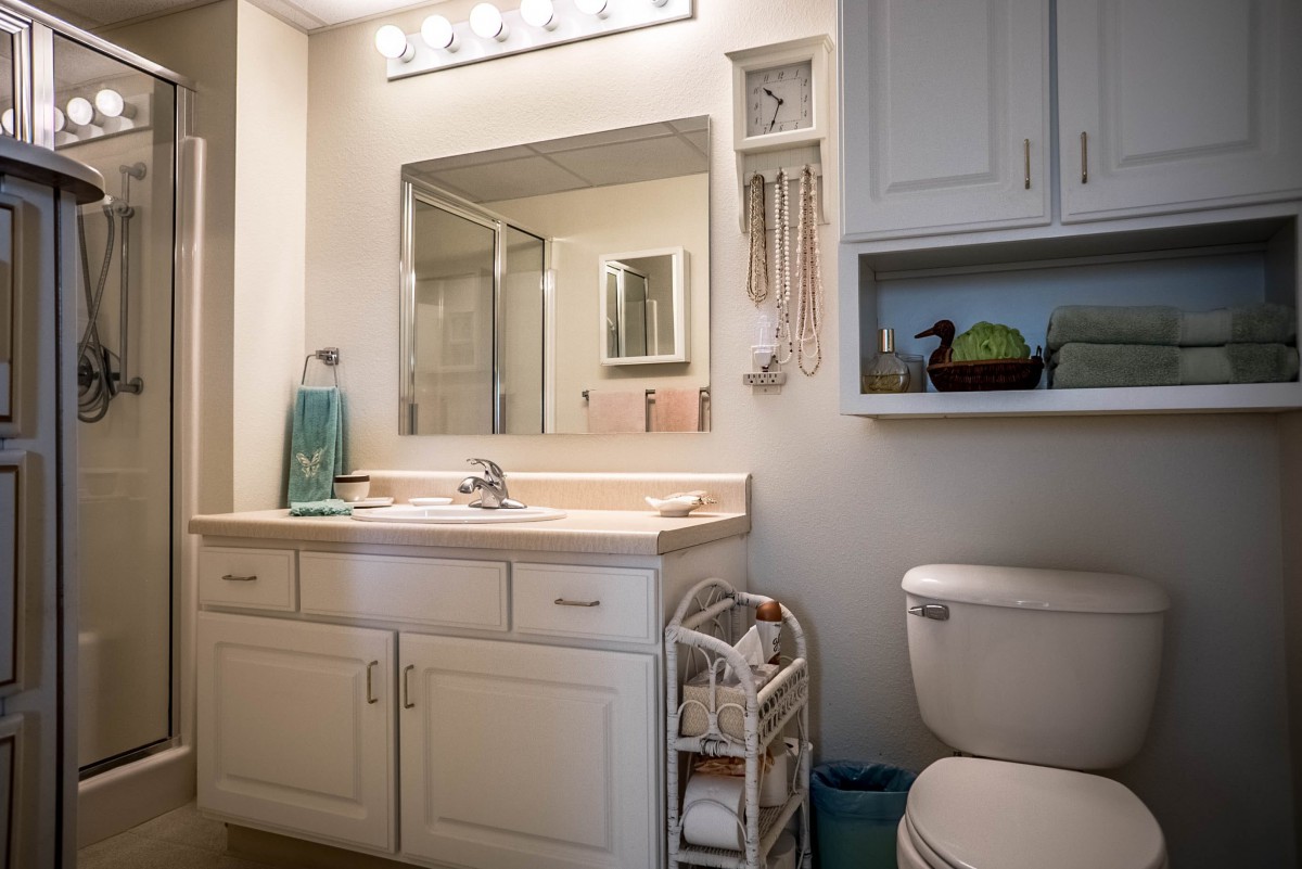 A tidy bathroom with a vanity, mirror, and cabinet.