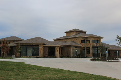 A modern residential house with a unique architectural design and spacious front area.
