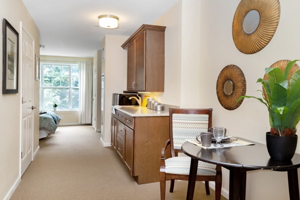 A modern interior with a kitchen and dining area featuring wooden cabinets and contemporary decor.