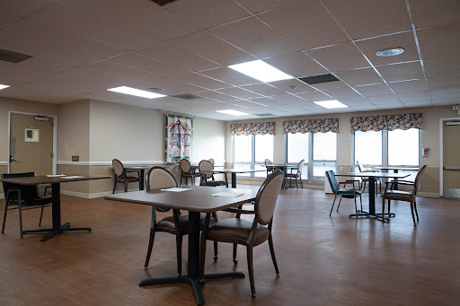 A spacious and well-lit dining area with tables and chairs, ready for guests.