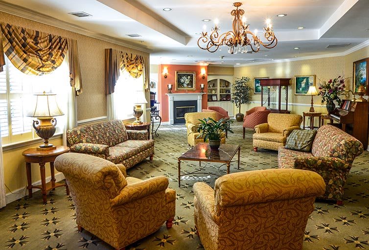 A cozy living room with elegant furniture and a warm fireplace.