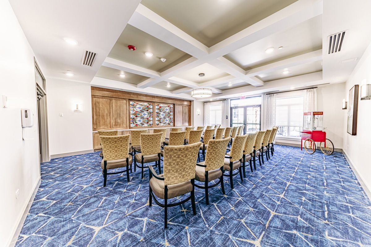 A well-lit conference room with rows of chairs arranged for a meeting or event.