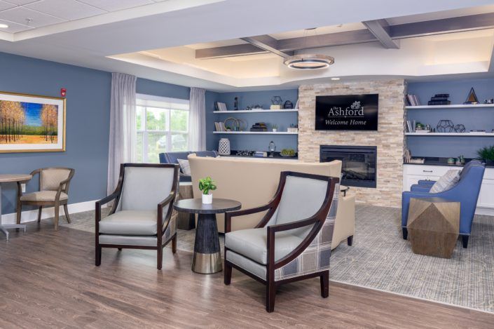 A modern living room with cozy seating, a fireplace, and stylish decor.