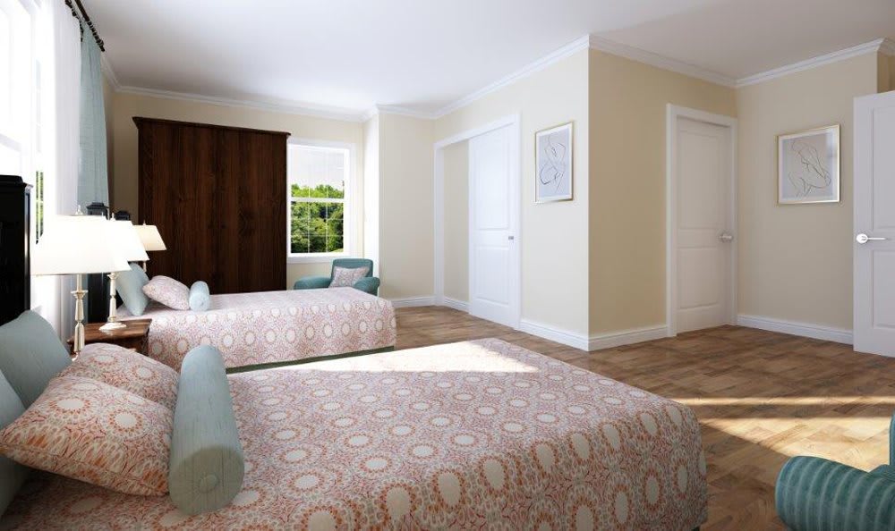 A cozy bedroom with two beds and a window letting in natural light.