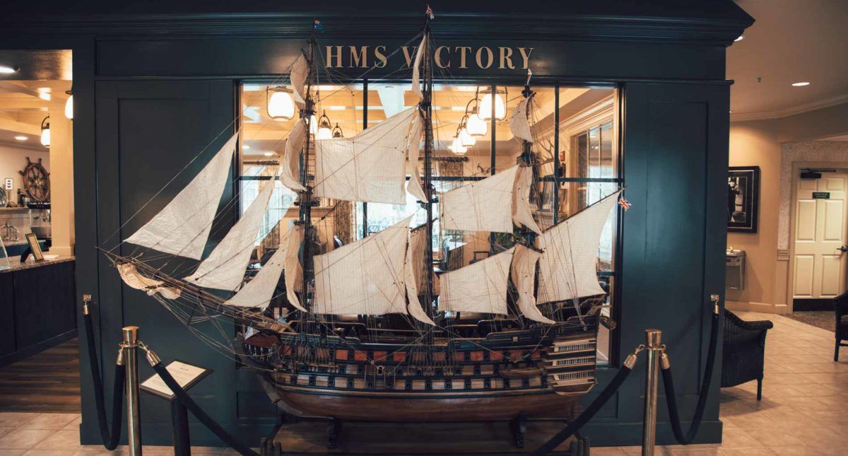 A detailed model of HMS Victory displayed in a museum setting.