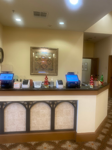 A view of a hotel reception area showcasing the checkout counter with computers and decorative elements.