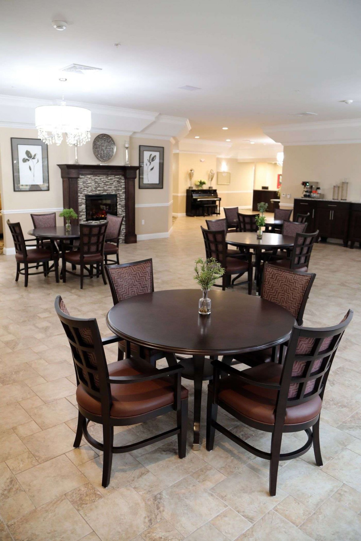 A spacious dining area featuring multiple tables and chairs, elegantly designed with tasteful decor.