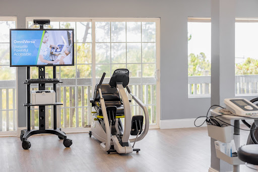 A modern exercise bike positioned near large windows, creating a bright and inviting workout area.
