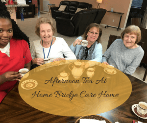 A group of elderly people enjoying afternoon tea at Home Bridge Care Home.