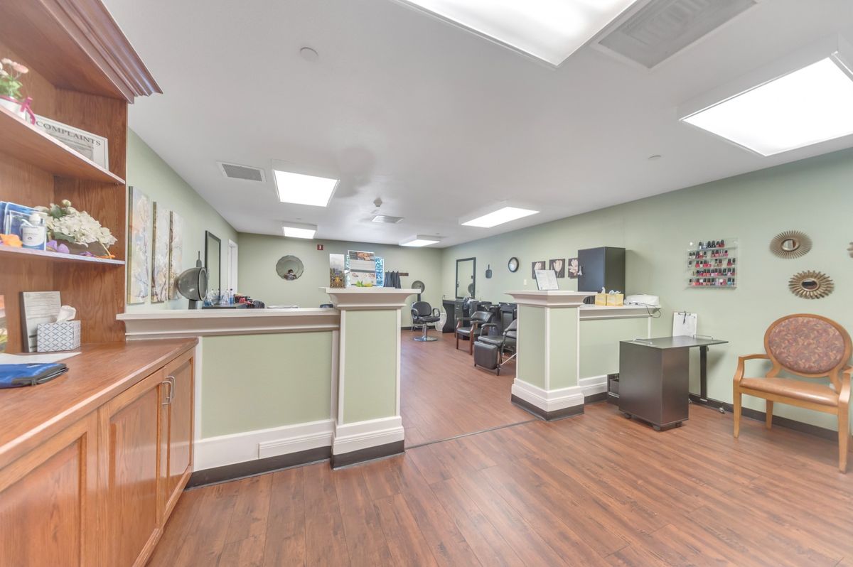 A spacious and well-lit reception area with desks and chairs, designed for welcoming visitors.