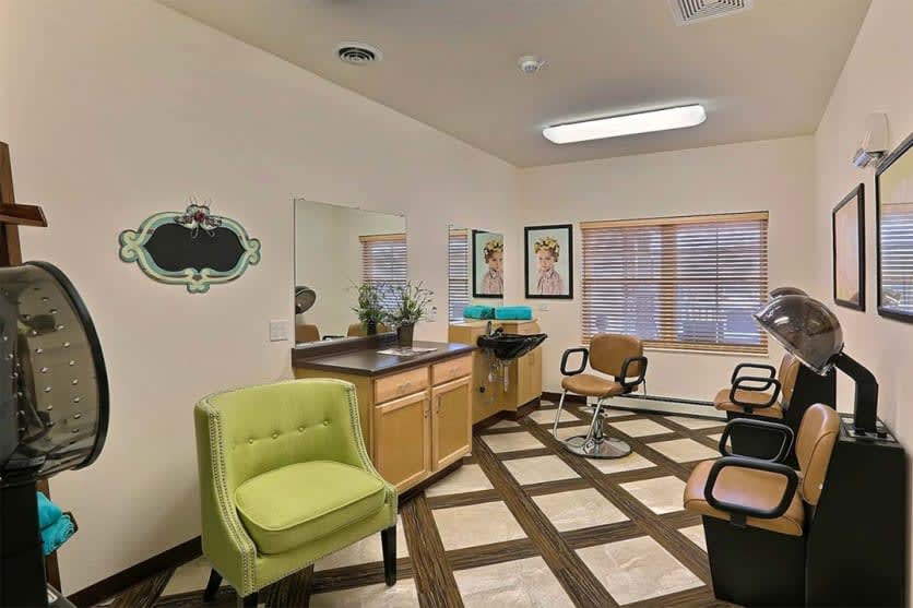 A well-lit hair salon with stylish chairs and modern decor.