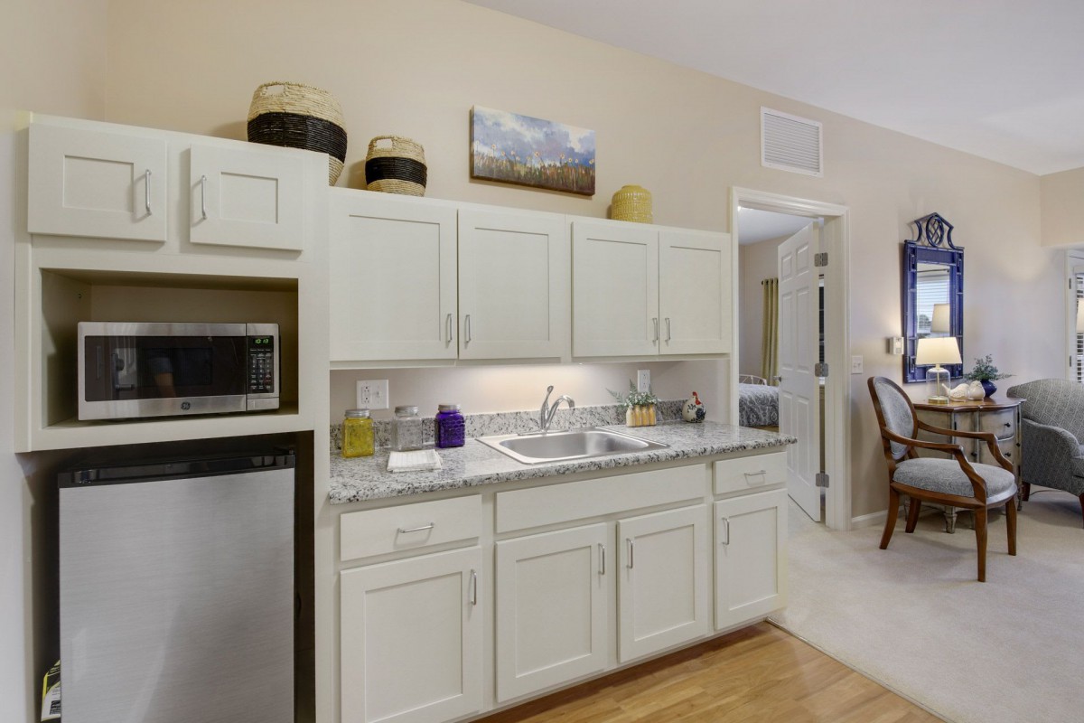 A modern kitchen with white cabinets and a dual-basin sink.