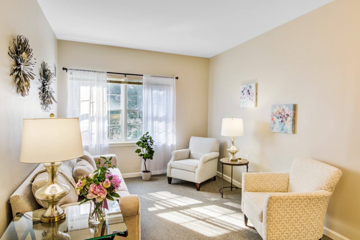 A bright and cozy living room with comfortable armchairs, a sofa, and tasteful decor.