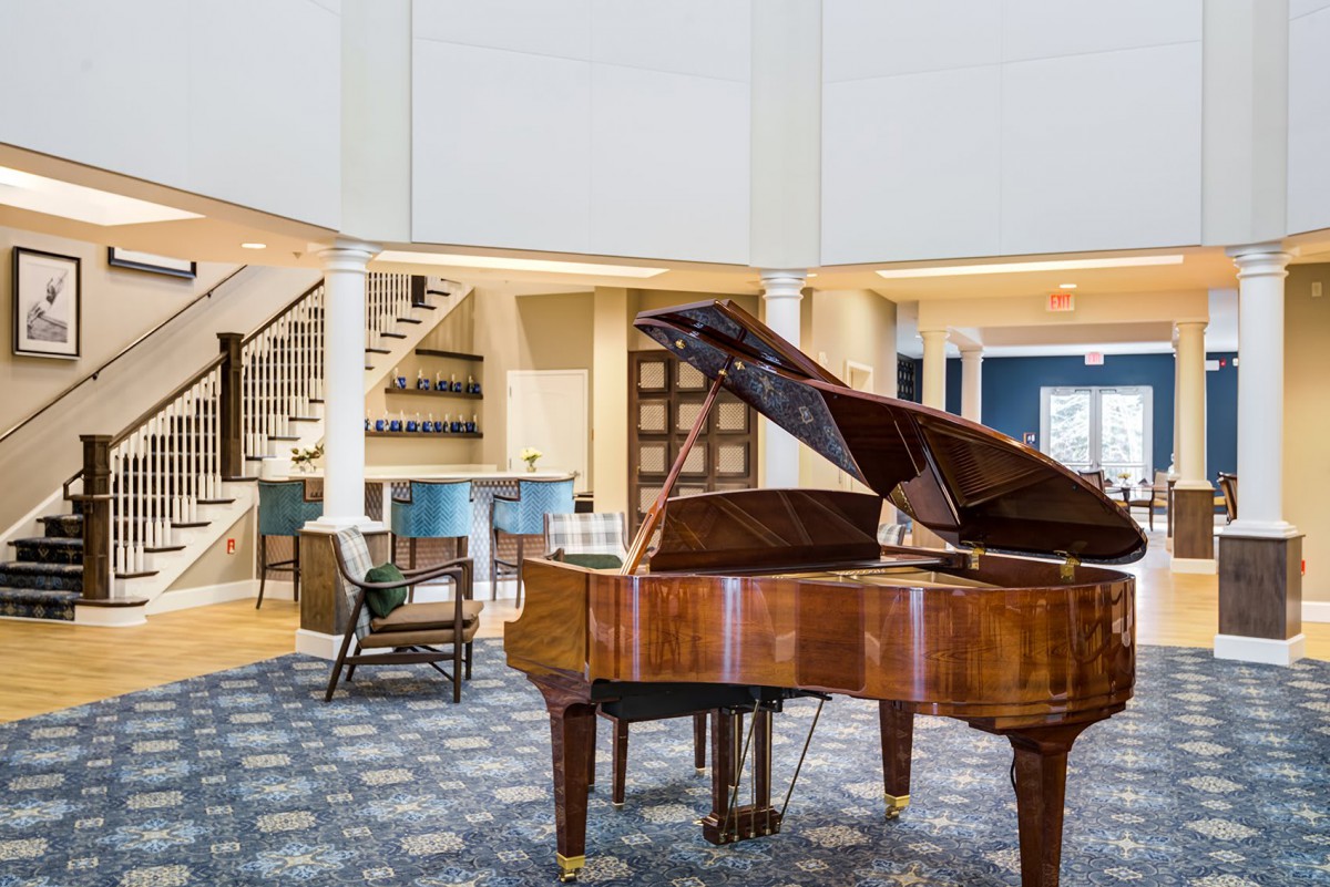 A luxurious living room featuring a grand piano, showcasing modern interior design and elegant furnishings.