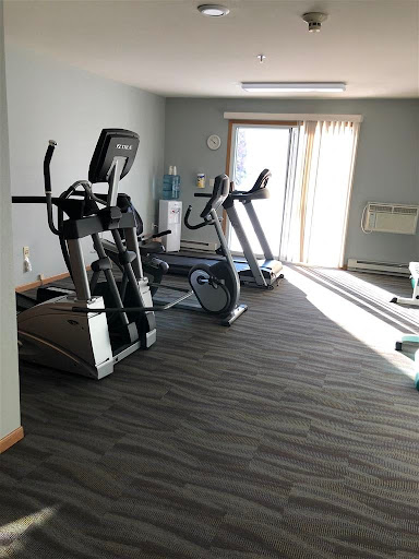 A well-equipped gym area featuring various exercise machines.