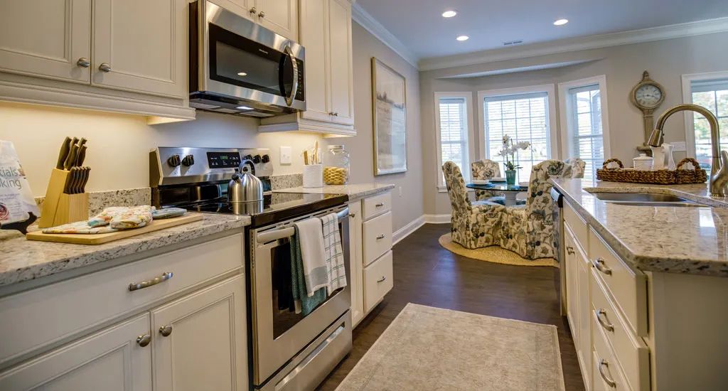 A modern kitchen with stainless steel appliances and a cozy dining area.