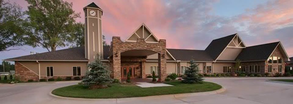 A beautifully designed building entrance with a sunset sky in the background.