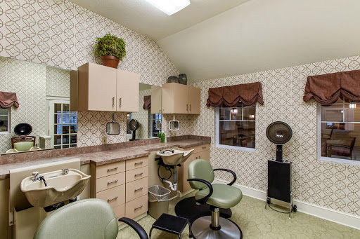 A cozy hair salon interior featuring stylish furniture and a warm atmosphere.