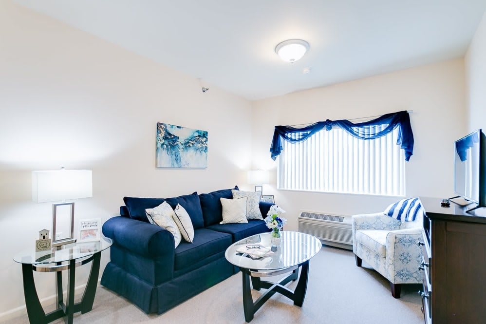 A cozy living room with blue and white decor featuring a comfortable sofa and a stylish coffee table.