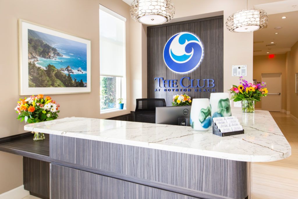 Modern reception area with a prominent logo and decorative elements.