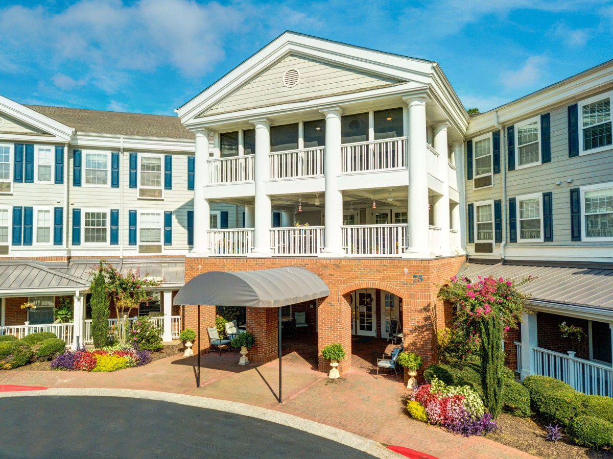 A well-maintained residential building with a welcoming entrance and vibrant landscaping.