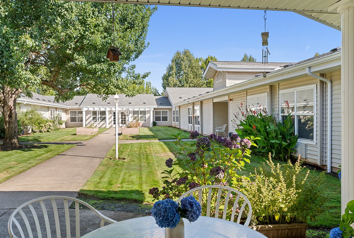 A peaceful courtyard with well-maintained gardens and outdoor seating.