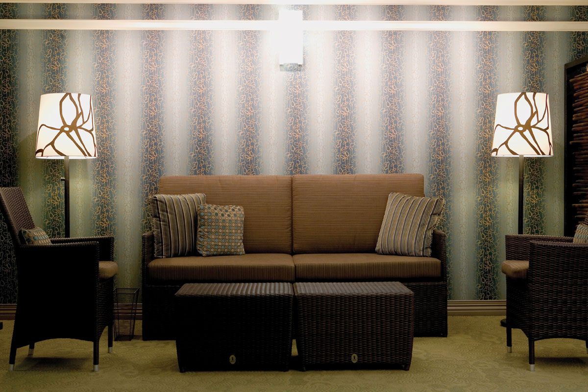 A modern living room with a stylish sofa and accent pillows against a textured wall.