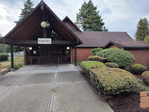 A welcoming entrance to a building surrounded by neatly trimmed bushes.