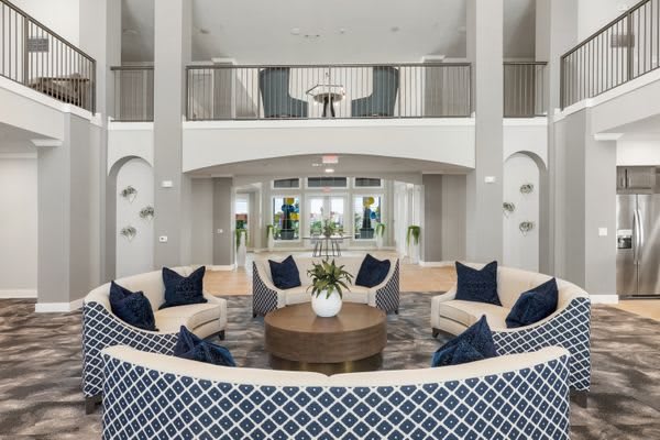 A modern living room featuring a stylish arrangement with sofas, a central coffee table, and elegant decor.