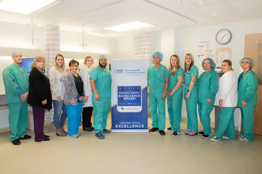 A dedicated healthcare team poses for a group photo in a hospital setting, showcasing their commitment to patient care.