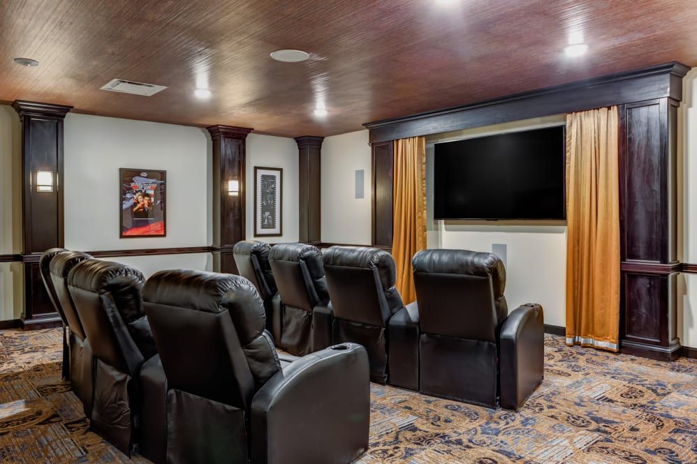 A cozy home theater with recliner seating and a large screen for an immersive viewing experience.