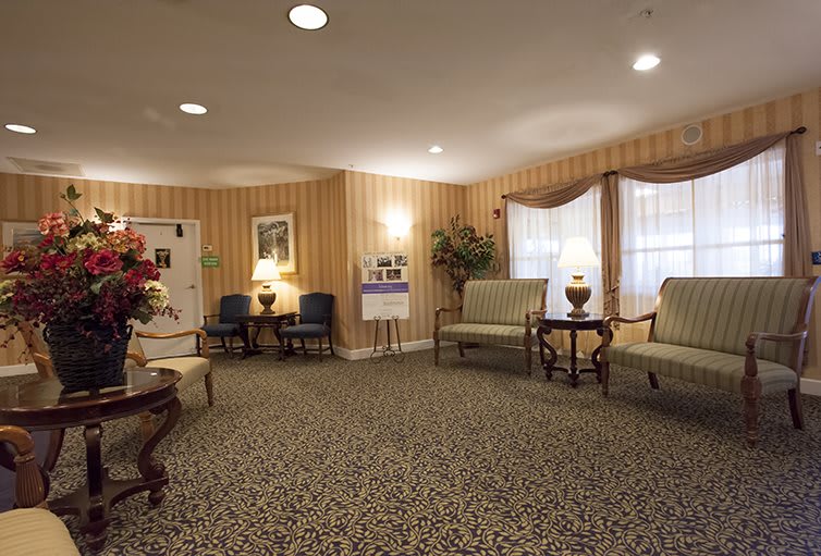 A cozy waiting room with comfortable seating and warm lighting.