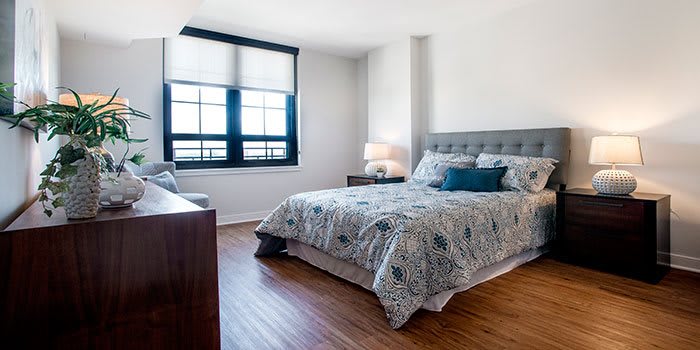 A modern bedroom with stylish decor and natural light.