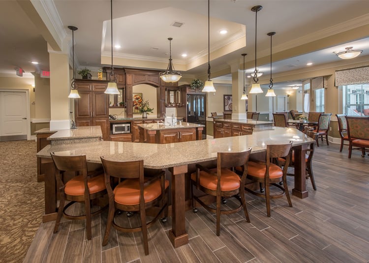 A spacious, modern kitchen with an island and wooden cabinets.