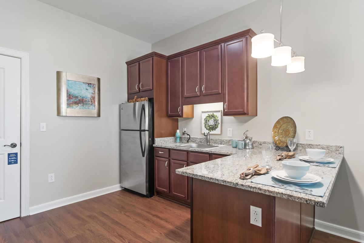 Modern kitchen with granite countertops and stainless steel appliances.