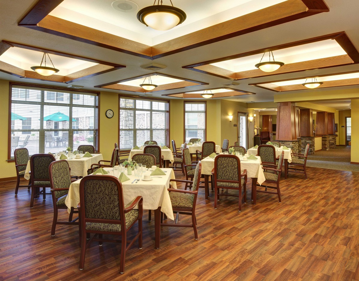 A well-lit dining area with neatly arranged tables and chairs.