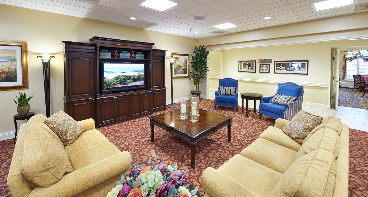 A cozy living room with comfortable seating, a television, and tasteful decor.