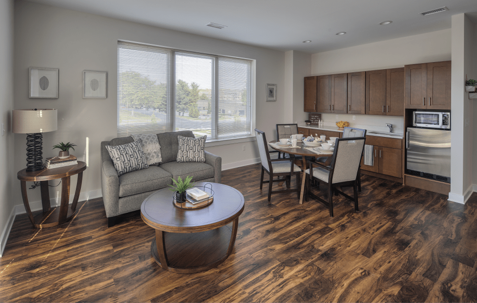 A modern open-concept living and dining area with wood flooring and contemporary furnishings.