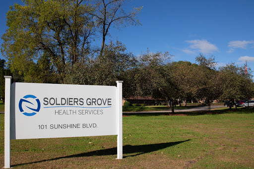 Sign at Soldiers Grove Health Services on a sunny day.