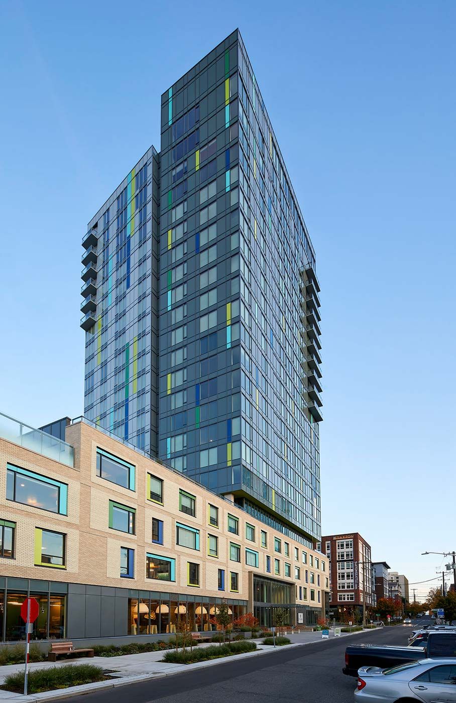 A modern skyscraper with a glass facade towering over the city.