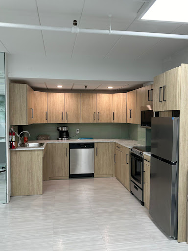 A modern kitchen featuring wooden cabinets and stainless steel appliances.