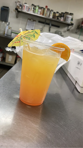 A vibrant cocktail with a hint of orange, garnished with an umbrella for that tropical feel.