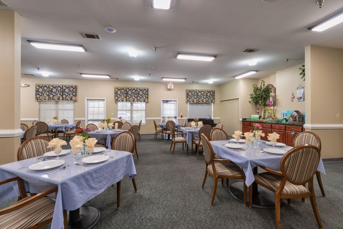 A well-decorated dining room with tables set for a meal.
