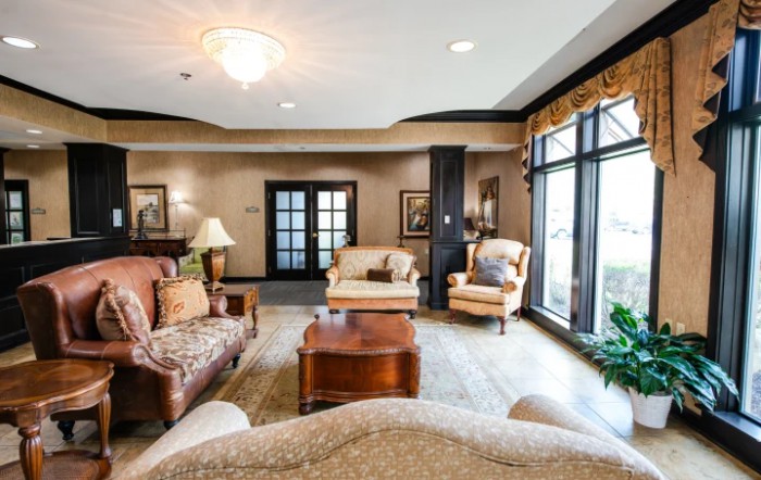 A cozy and elegantly decorated living room with comfortable seating and large windows.