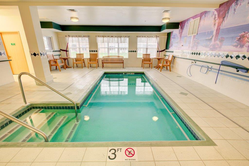 An inviting indoor swimming pool area in a hotel setting.