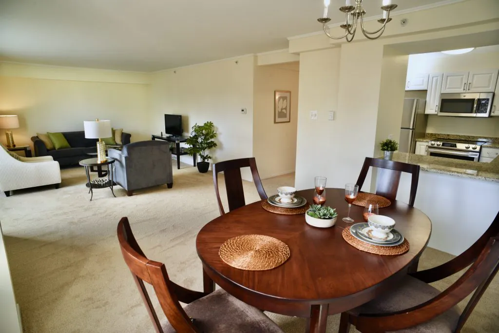 A spacious open-plan dining and living area featuring elegant furniture and decor.