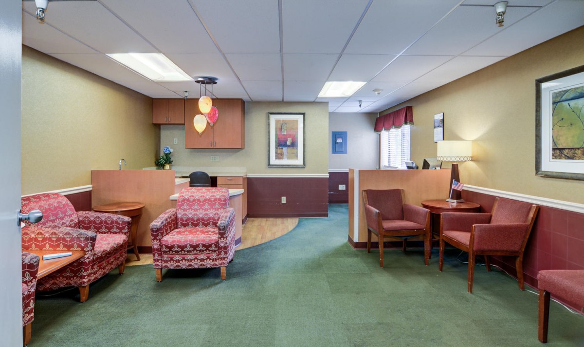 A welcoming office reception area with comfortable seating and warm decor.