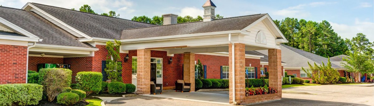 A brick building with a covered entrance and pathway.